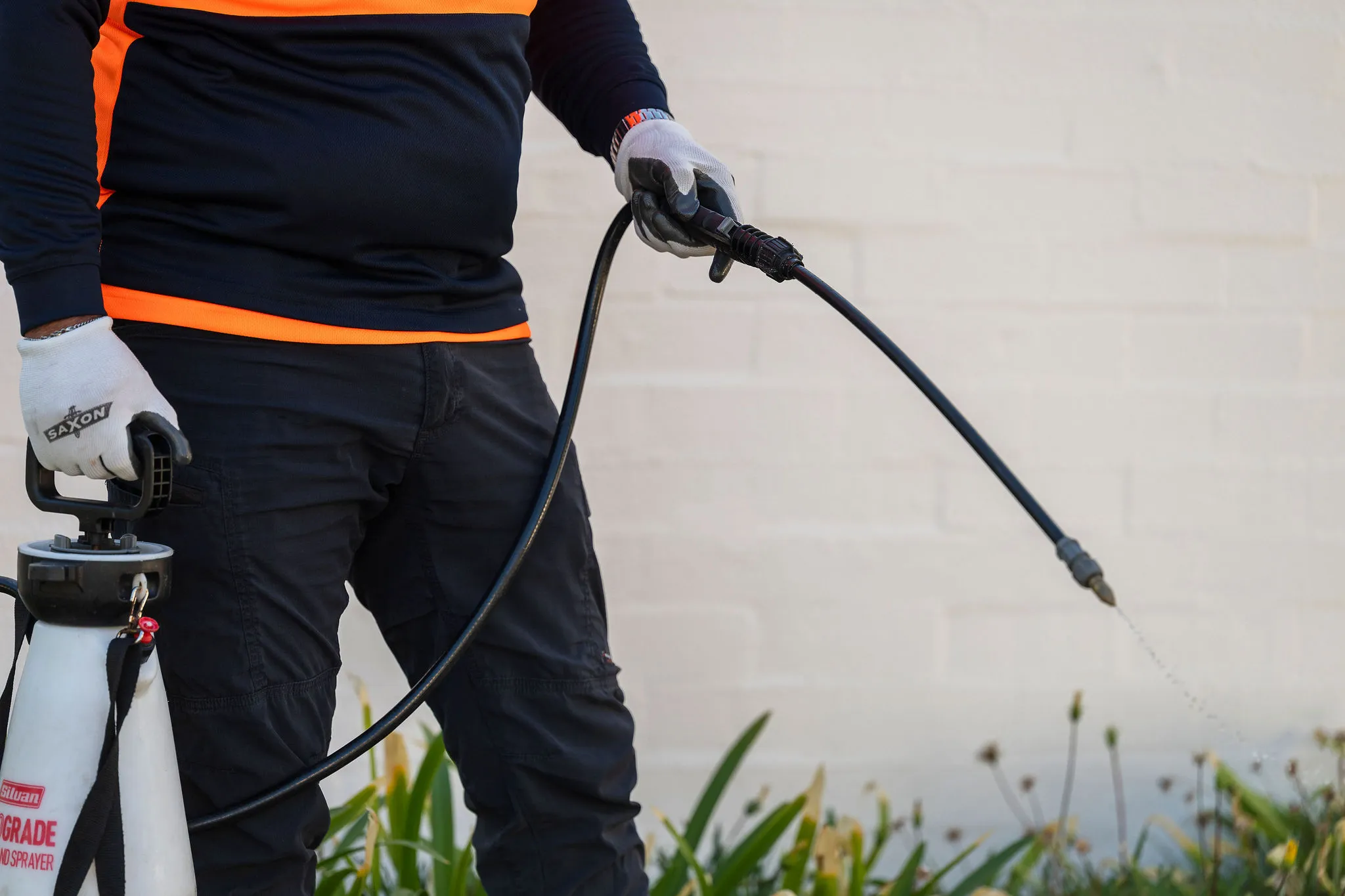 Swan Gardens Evolution team member applying weed and pest treatment at a Perth property.